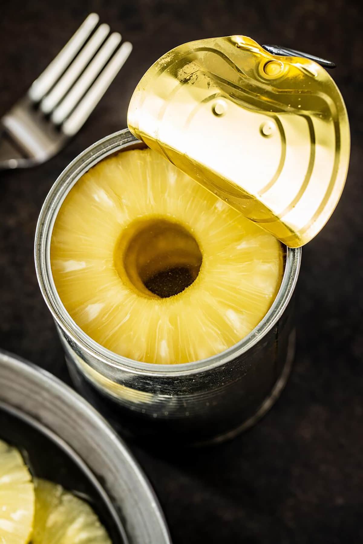 A can of Dole pineapple on a kitchen counter ready to be added to recipes
