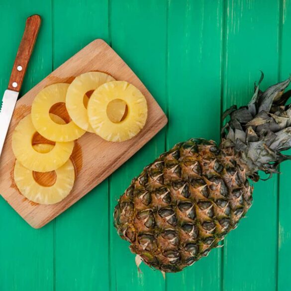Freshly sliced ripe pineapple on a wooden cutting board Sliced fresh pineapple served on a wooden board