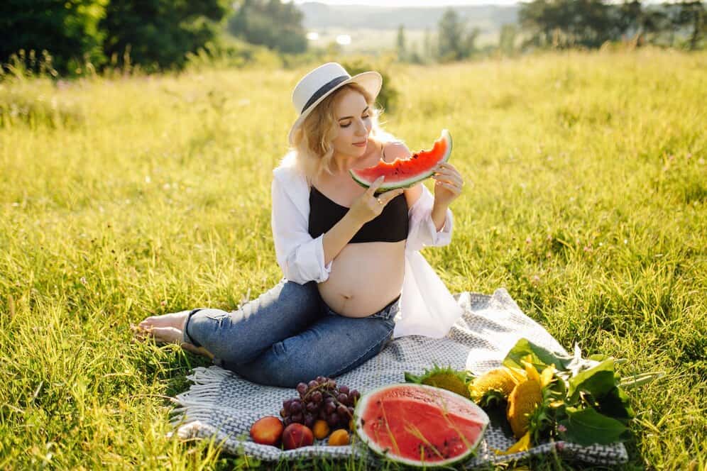 Pregnant woman eating watermelon to satisfy cravings
