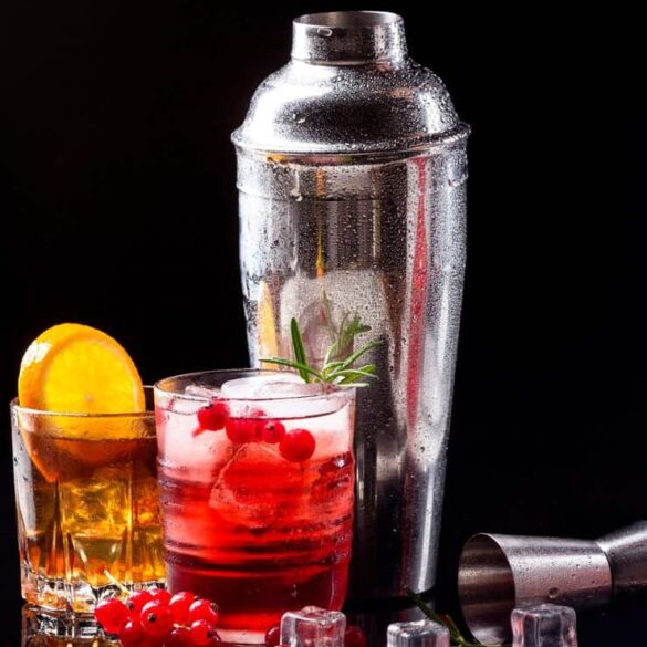 Vibrant Strfkr Shot on a Bar Counter with Red Bull A Strfkr Shot served in a shot glass with Red Bull and watermelon schnapps beside it