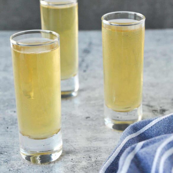 Water Moccasin Shot Served Cold in Tall Glasses Three chilled Water Moccasin Shots in tall shot glasses on a marble surface