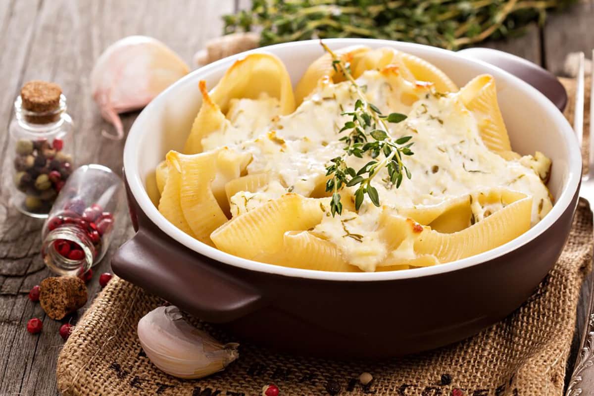 Baked ricotta-stuffed pasta shells topped with marinara sauce and melted mozzarella cheese